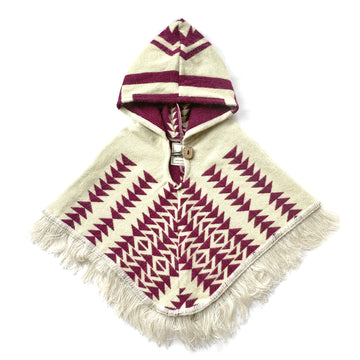 front of baby and toddler poncho with a hood and fringe in the bottom with a background color of white and plum color  arrows
