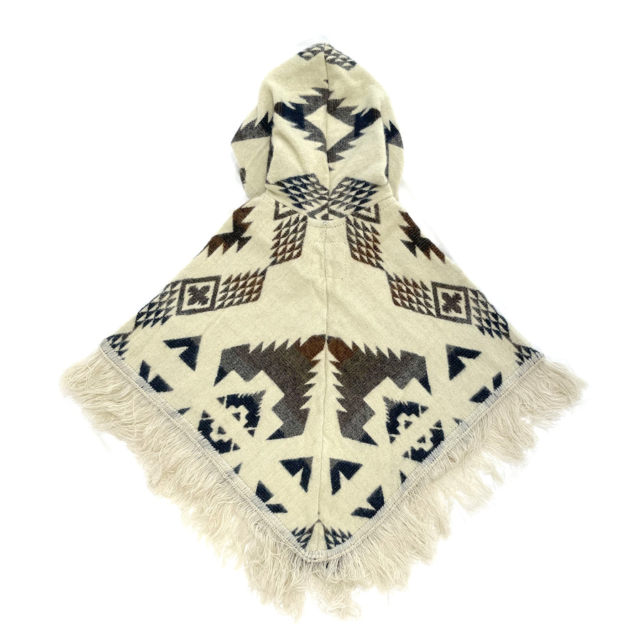 back of baby poncho with a hood and fringe with a cream color background and gray, brown and blue patterns