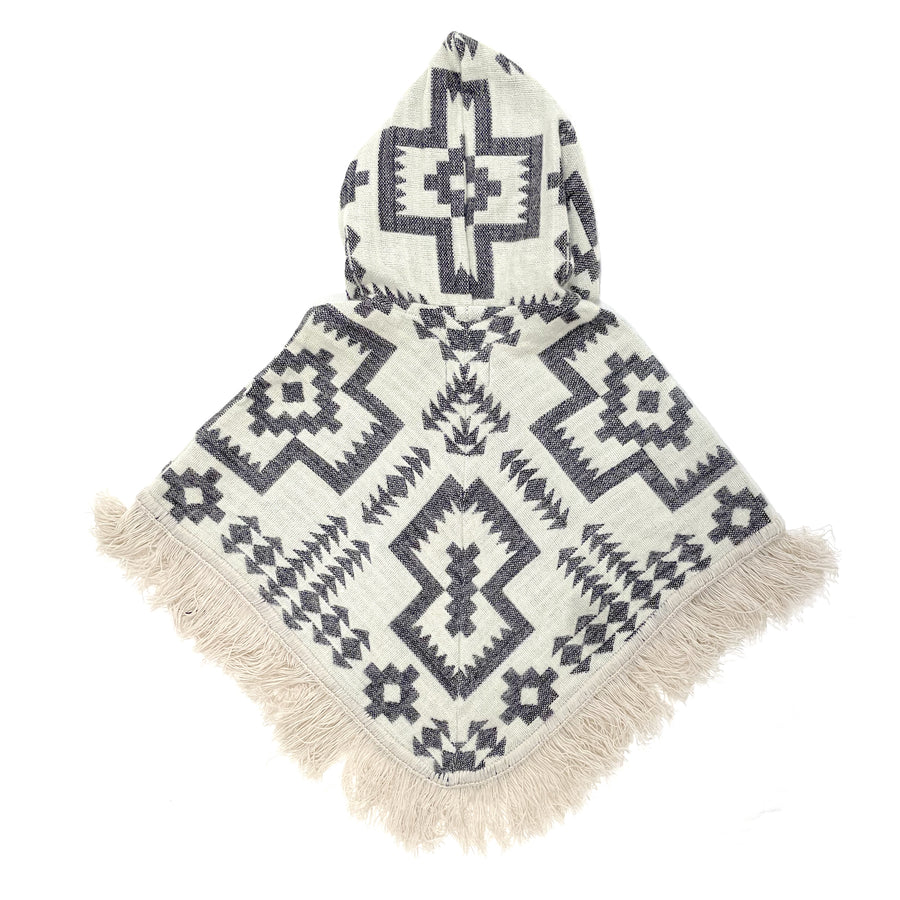 back of baby poncho with hood and fringe with a base cream color and a pattern of crosses and arrows and stars in a lavender color 