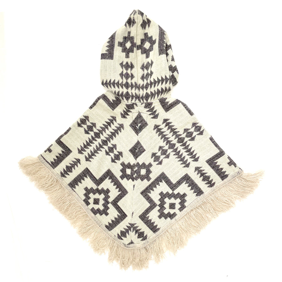 back of baby poncho with hood and fringe with a base cream color and a pattern of crosses and arrows and stars in a lavender color 