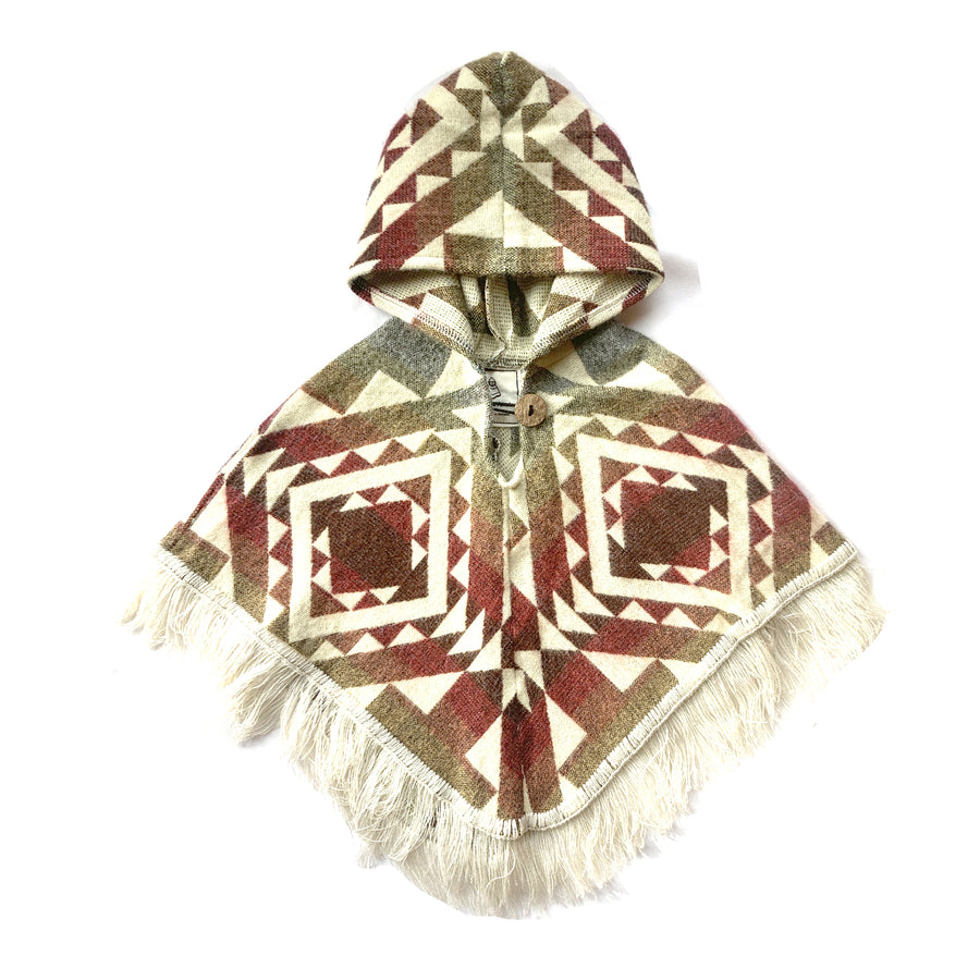 front of baby and toddler poncho with hood and fringe in the bottom, with colors red, orange, yellow with white patterns on top