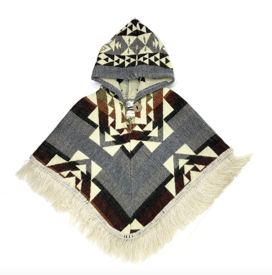 front of baby poncho with gray and also some color stripes in dark red, orange and yellow and  a design of squares and triangles in white. the hood is gray with black and white shapes