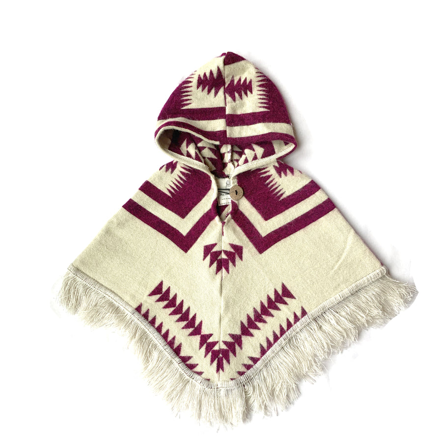 front of baby and toddler poncho with hood and fringe in the bottom in white and with a plum color pattern on top