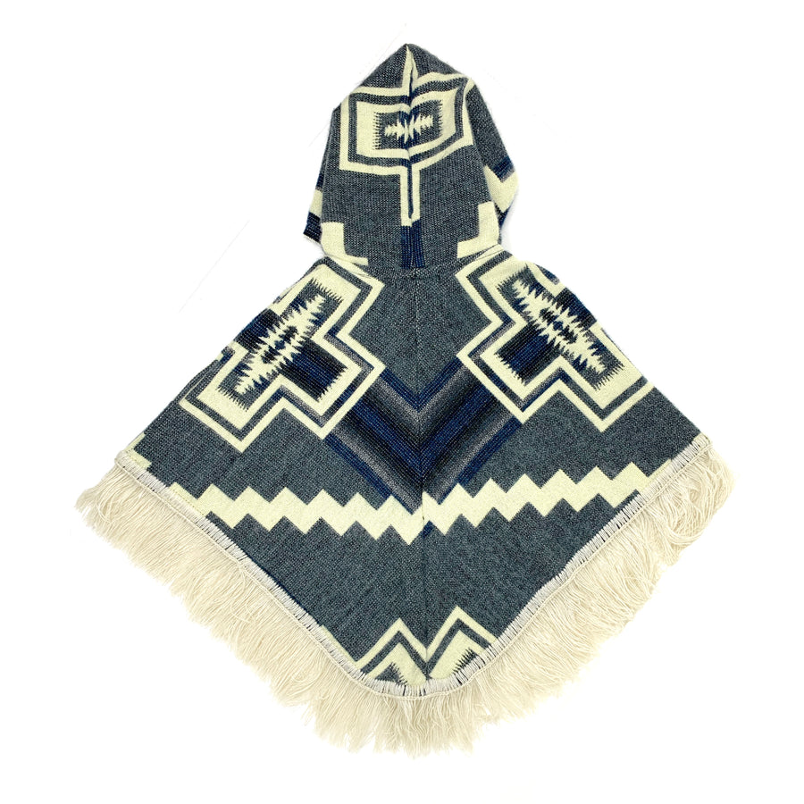 back of baby poncho in a denim color blue with white crosses on each side and a white zigzag line across horizontally. the hood has a white cross