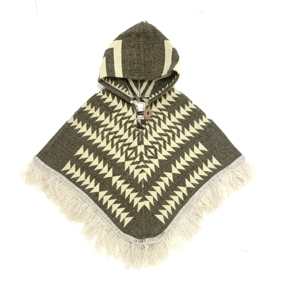  front of baby and toddler poncho with a hood and fringe with a base color of a gray brown and cream color arrows on top