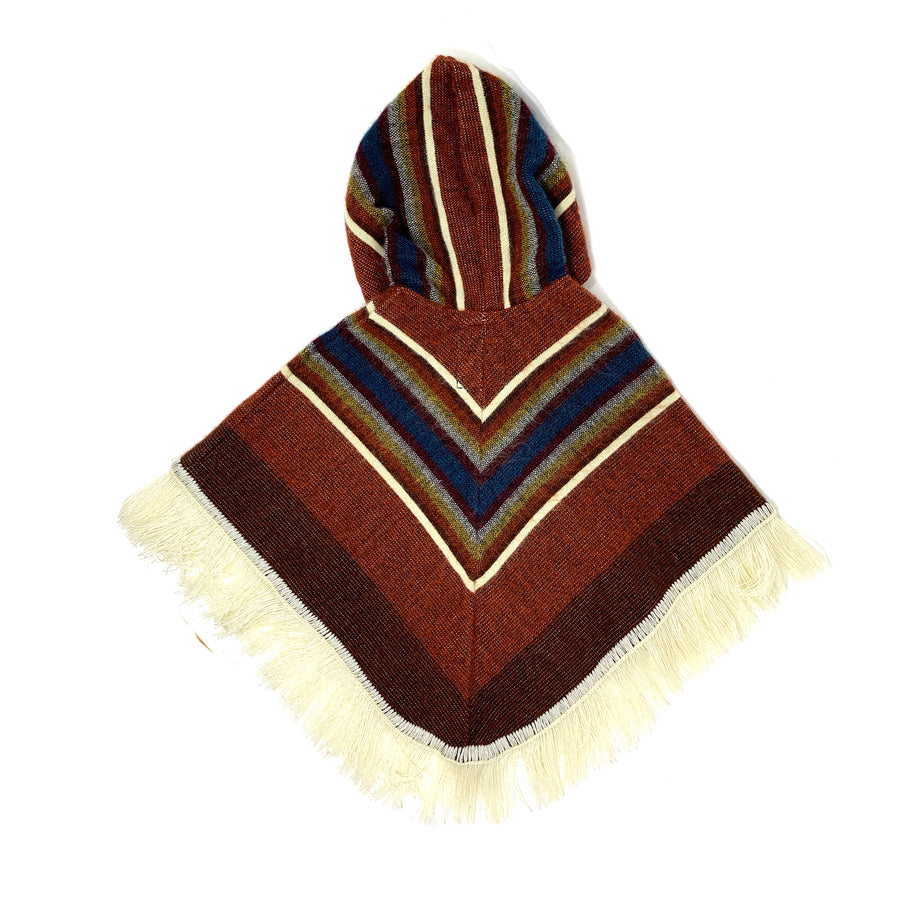 back of poncho is a siena color with a v shape stripes in white and blue. the hood also has some stripes
