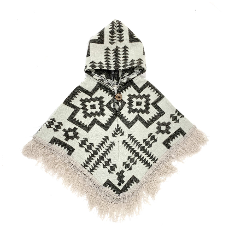 front of baby and toddler poncho with a hood and fringe with a cream base color and gray designs of crosses and arrows 